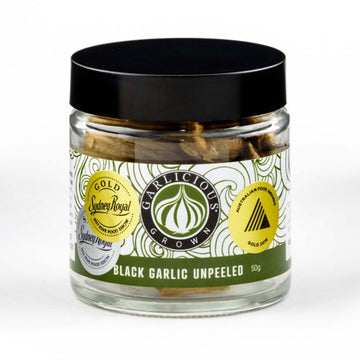 A clear jar with a wide product label with the title 'Black Garlic Unpeeled'.