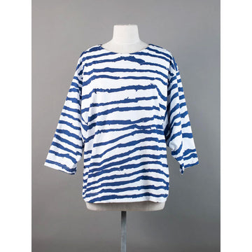 Front view of a blue and white striped long sleeve top on a mannequin against a gray background.