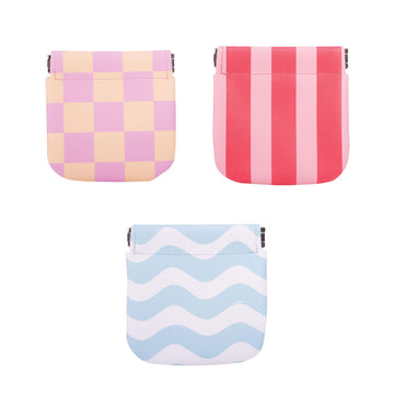 Three travel pouches each printed with a different pattern and colours.