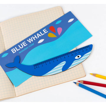 A blue whale shaped ruler swimming in an ocean image.