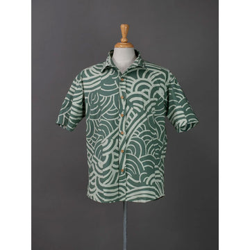 Front view of a green patterned shirt on a mannequin against a gray background.