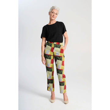 A pair of women's pants printed with a green and red pattern.