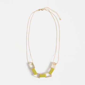 Necklace with geometric pendant on a light gray background.