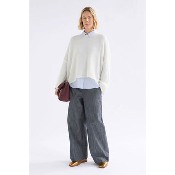 White long-sleeve sweater on a light gray background.