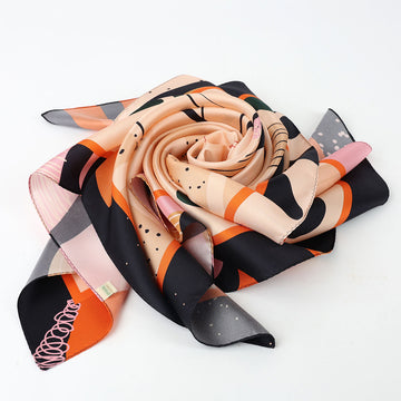 Decorative scarf with abstract leaf pattern on a beige background.