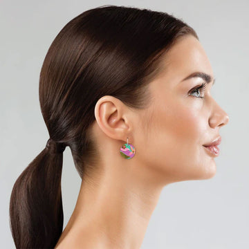 A pair of drop earrings with circles printed with floral artwork.