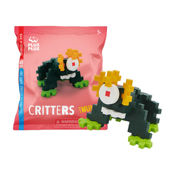 A pink packet with an image of a monster made from plus shaped pieces. The model is also pictured next to the bag.