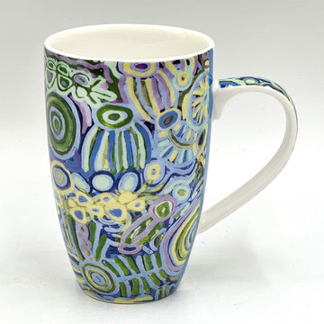 A ceramic mug in white printed with artwork by Cedric Varcoe in blue, purple and yellow.