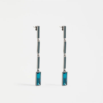 Pair of earrings with blue rectangular stones on a white background.