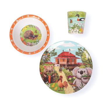 Children's tableware set with animal-themed plates, bowl, and cup on a white background.