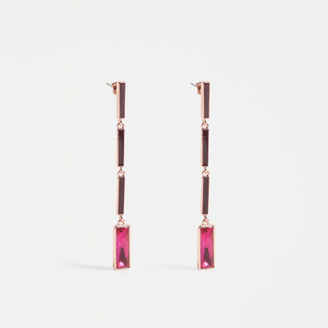 Rose gold earrings with pink gemstones on a light gray background.
