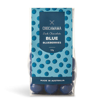 A clear bag filled with blue chocolate covered blueberries with a blue product label on the front.