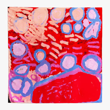 A square silk scarf printed with artwork by Rosie Tarku in red and blue.