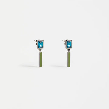 Pair of earrings with blue gemstones and green bars on a white background.
