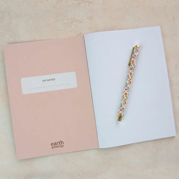Notebook with colorful bird illustrations on a light green background.