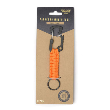A multi tool with a orange cord attached to a brown and black card.