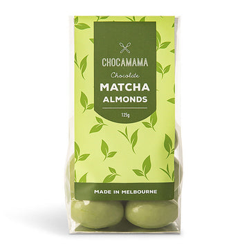 A clear bag filled with green chocolate covered almonds with a green product label attached.