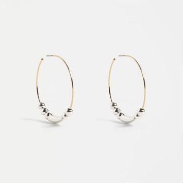 Pair of hoop earrings with spherical beads on a white background.