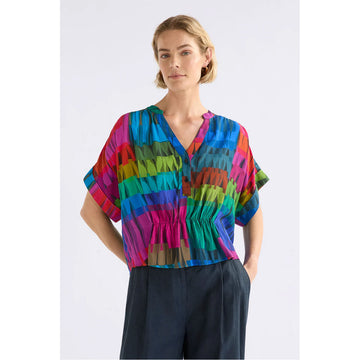 Colorful patterned blouse on a white background.