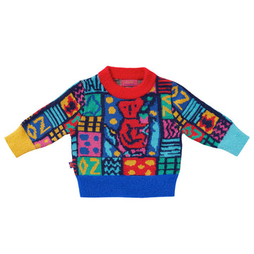 A knitted jumper in a colourful print with a red koala.