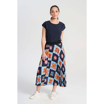 A pleated skirt printed with a star pattern in yellow and blue with a black waistband.