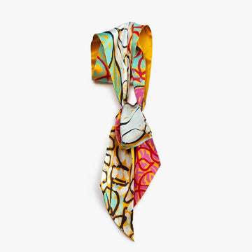 A silk scarf printed with artwork by Tommy May.