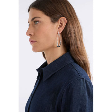 Pair of silver hoop earrings on a white background.