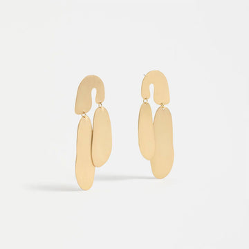 Gold earrings on a light gray background.