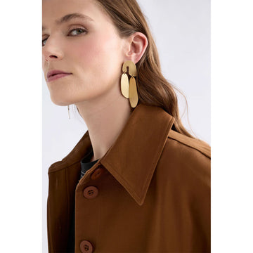 Gold earrings on a light gray background.