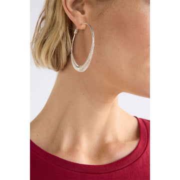 Pair of silver hoop earrings on a light gray background.