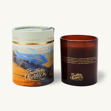 Candle and packaging with 'Southern Wild Co' branding on a white background.
