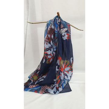 Navy blue scarf with colorful floral pattern draped over a stand on a white background.