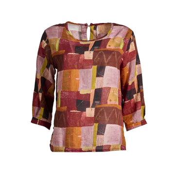 A women's blouse printed with an abstract rectangle pattern in shades of red.