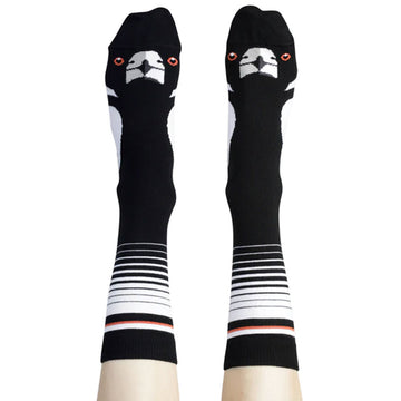 A pair of tall socks as shown on a person's legs and feet illustrated with a magpie's face.