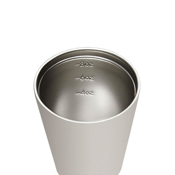 White coffee tumbler with black lid on a white background, branded 'made by Fressko'.