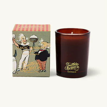 Candle with 'Southern Wild Co' branding next to its packaging on a white background