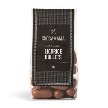 A clear bag filled with chocolate covered licorice bullets and a black product label.