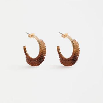 Pair of brown beaded hoop earrings on a light gray background.