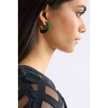 Green beaded hoop earrings on a white background.