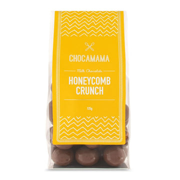 A clear bag filled with milk chocolate honeycomb bites with a yellow product label.