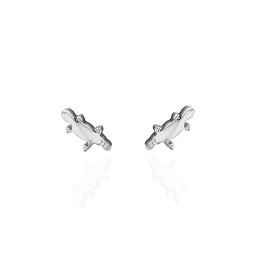 A pair of silver stud earrings shaped like a platypus.
