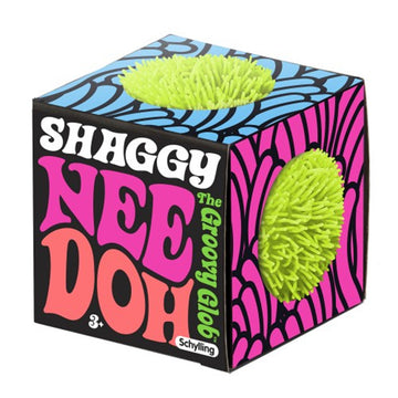 A stress ball with shaggy edges inside a cube box with the text 'Shaggy Nee Doh' written on the front.
