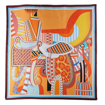 Colorful abstract design on a scarf with orange, yellow, and blue colors.
