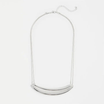 Silver necklace on a light gray background.