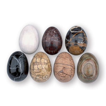 Seven marble eggs lined up in two lines, each one is a different coloured marble.