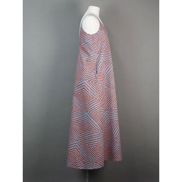 Front view of a patterned dress on a mannequin against a gray background.