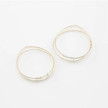 Gold hoop earrings on a white background.