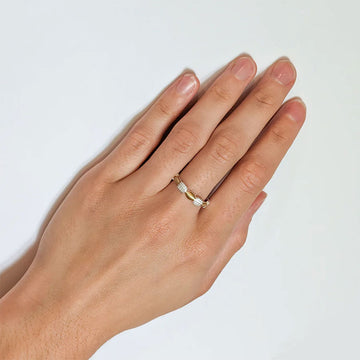 A ring featuring gold ovals and silver squares in an alternating pattern around the band.