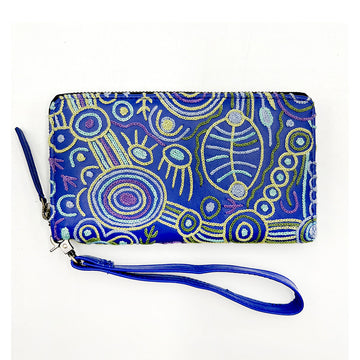 A dark blue purse embroidered with artwork by Cedric Varcoe in yellow and green with a dark blue wrist strap.