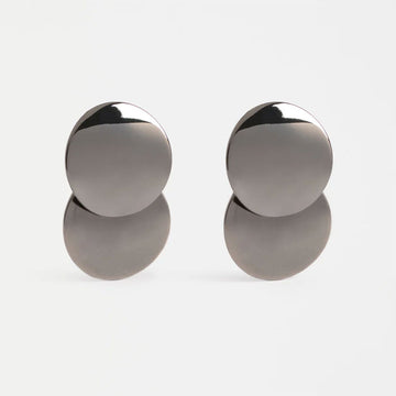 Pair of silver round earrings on a light gray background.